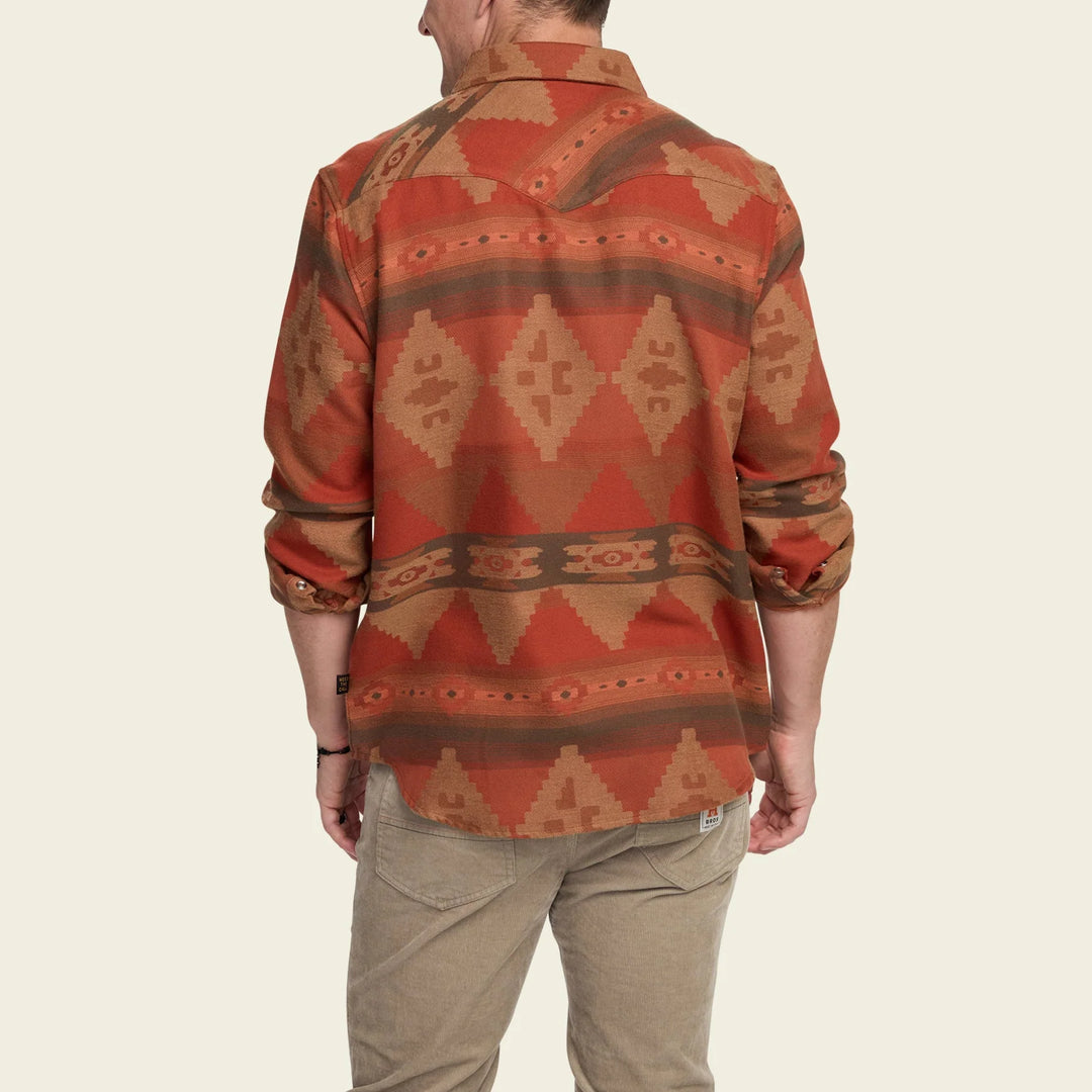 Person wearing a patterned shirt with a neutral background