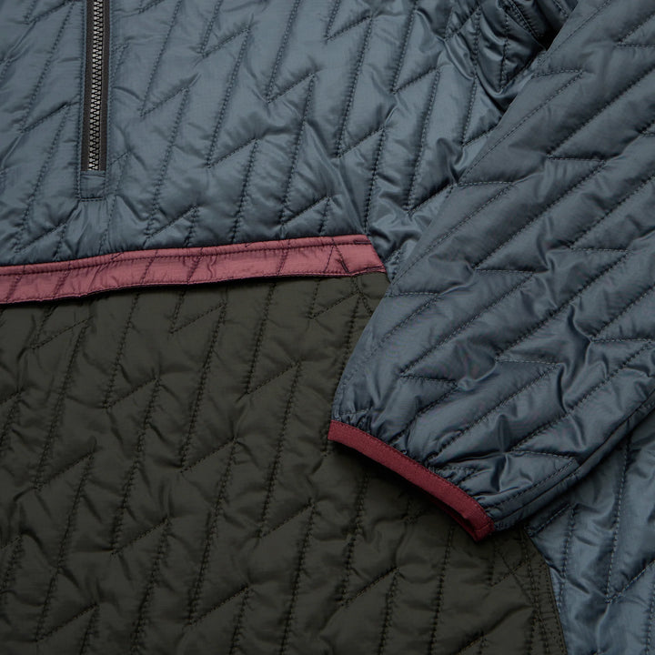 Close-up of a quilted jacket with blue and black patterns.