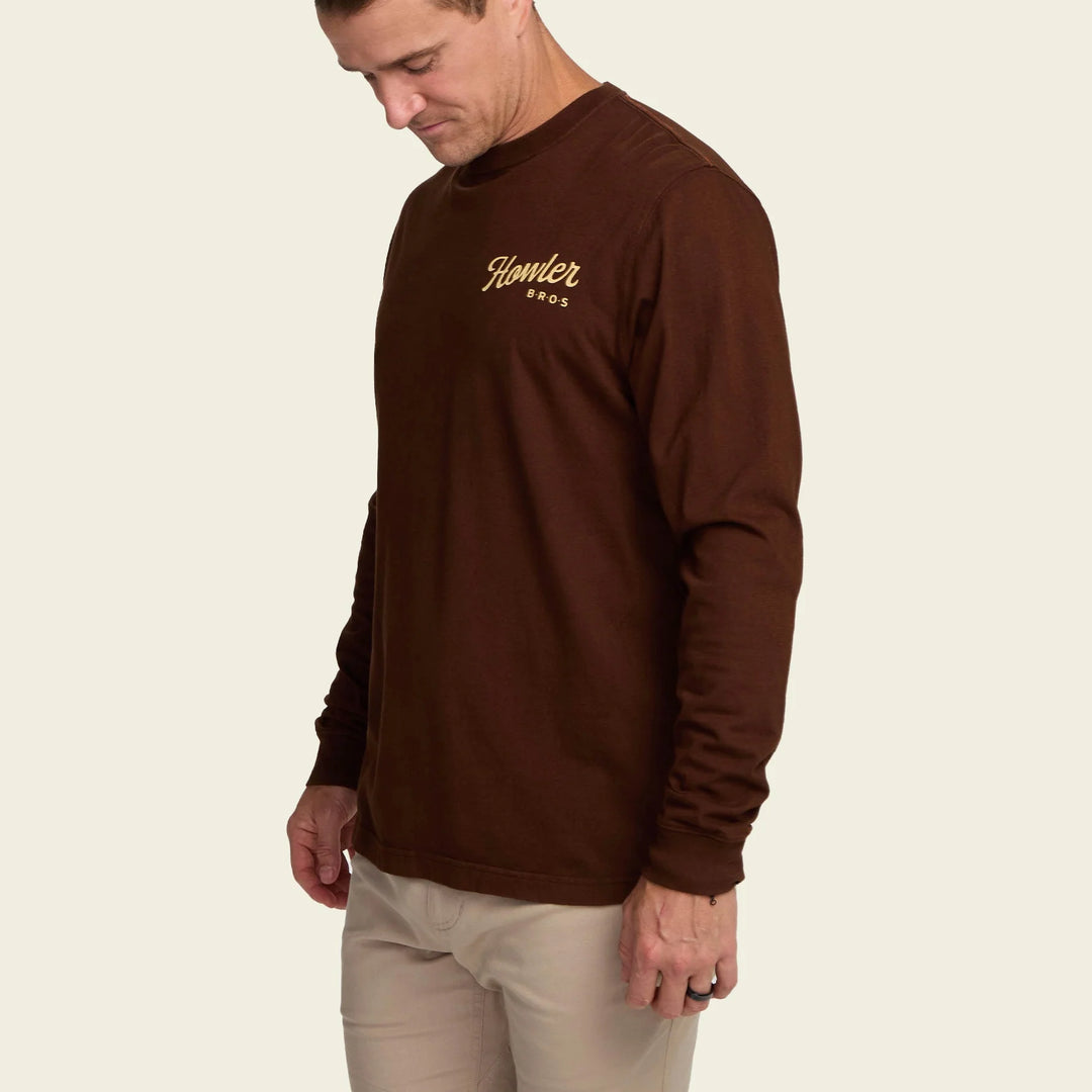 Man wearing a brown long-sleeve shirt with a logo on a beige background