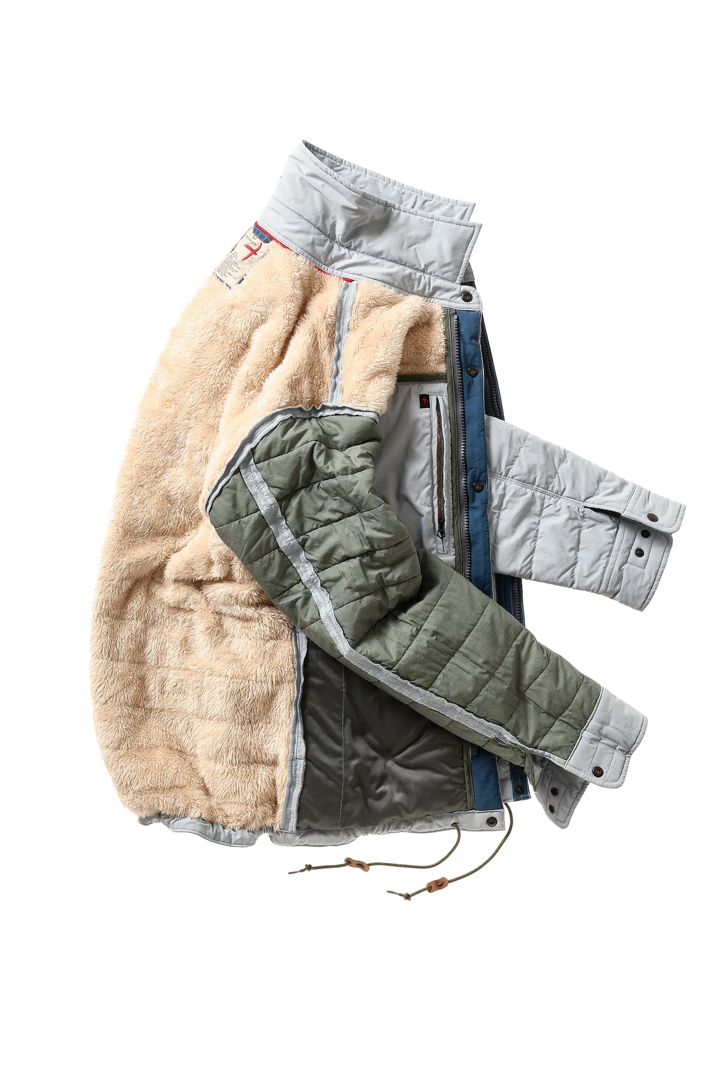 A vintage-style quilted jacket with a beige sherpa lining, olive green quilted sleeves, and light gray panels, shown on a solid white background.