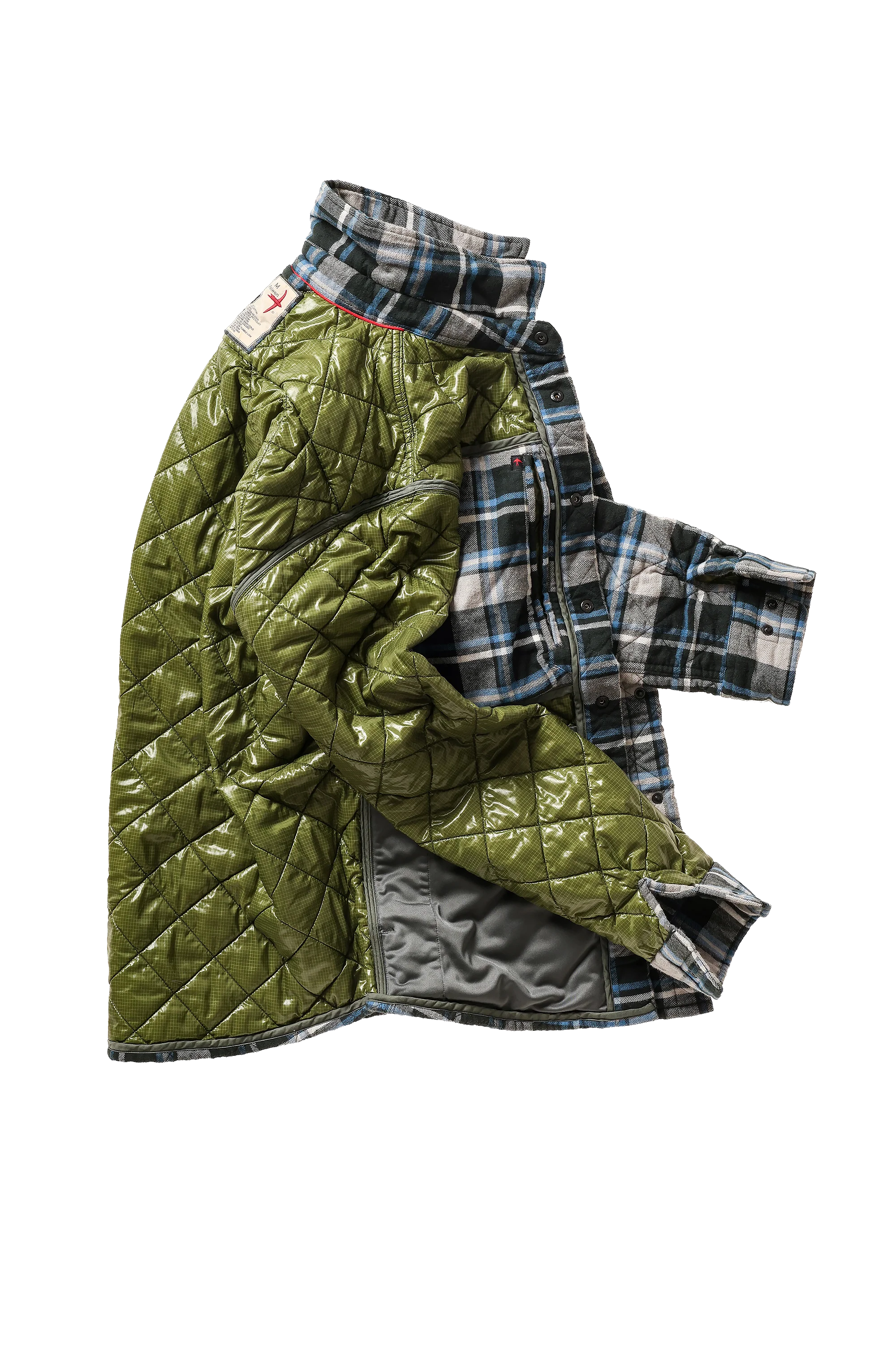 An olive green quilted jacket with a high collar, layered over a blue, white, and gray plaid flannel shirt. The jacket is shown open, revealing a gray interior lining, set against a plain white background.