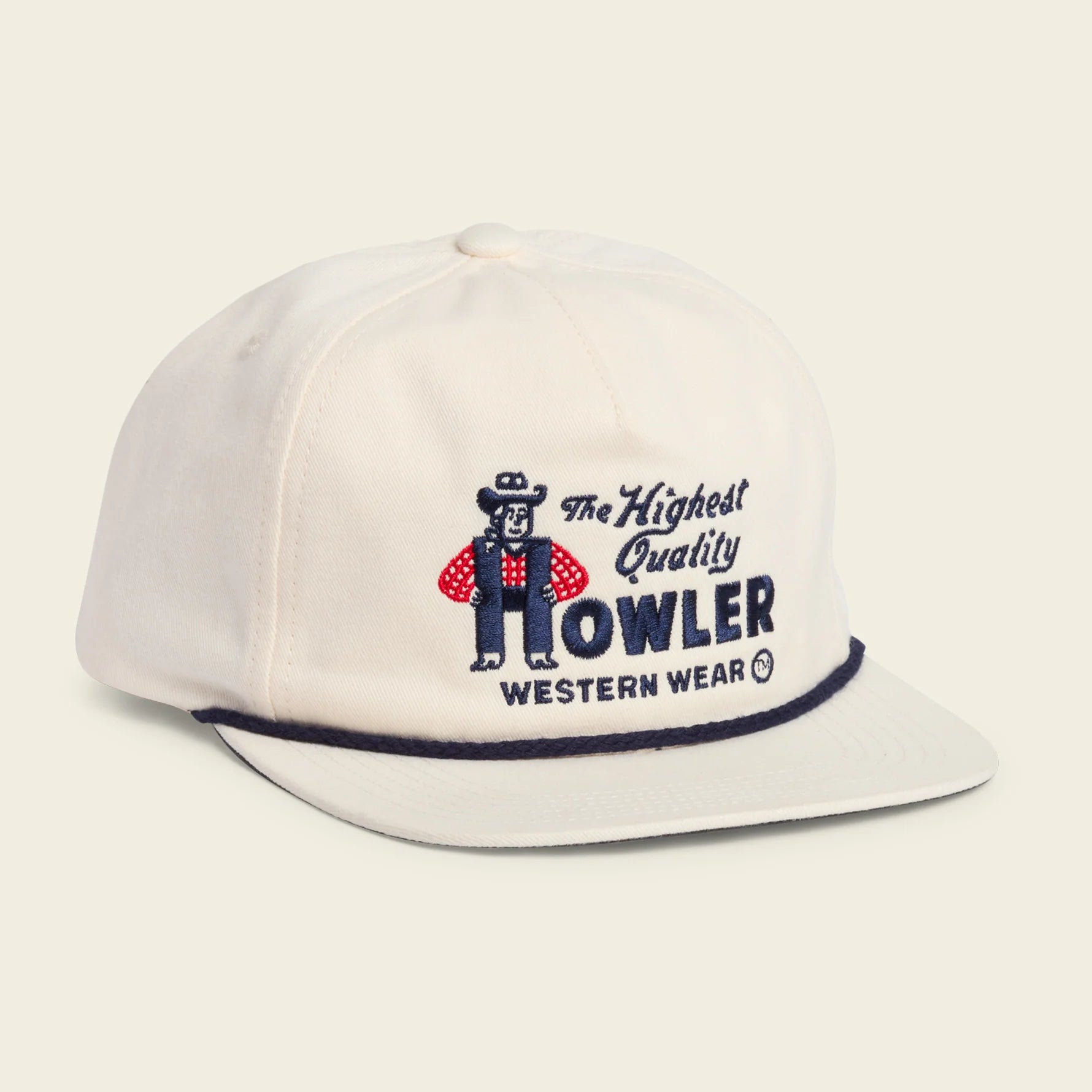 An off-white snapback cap featuring a vintage embroidered logo of 'The Howler Western Wear' with a cowboy mascot, set against a solid cream background.