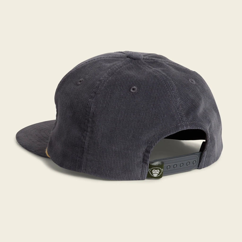 A dark charcoal gray corduroy baseball cap shown from a rear three-quarter angle on a white background, featuring an adjustable snapback closure with a small circular brand patch.