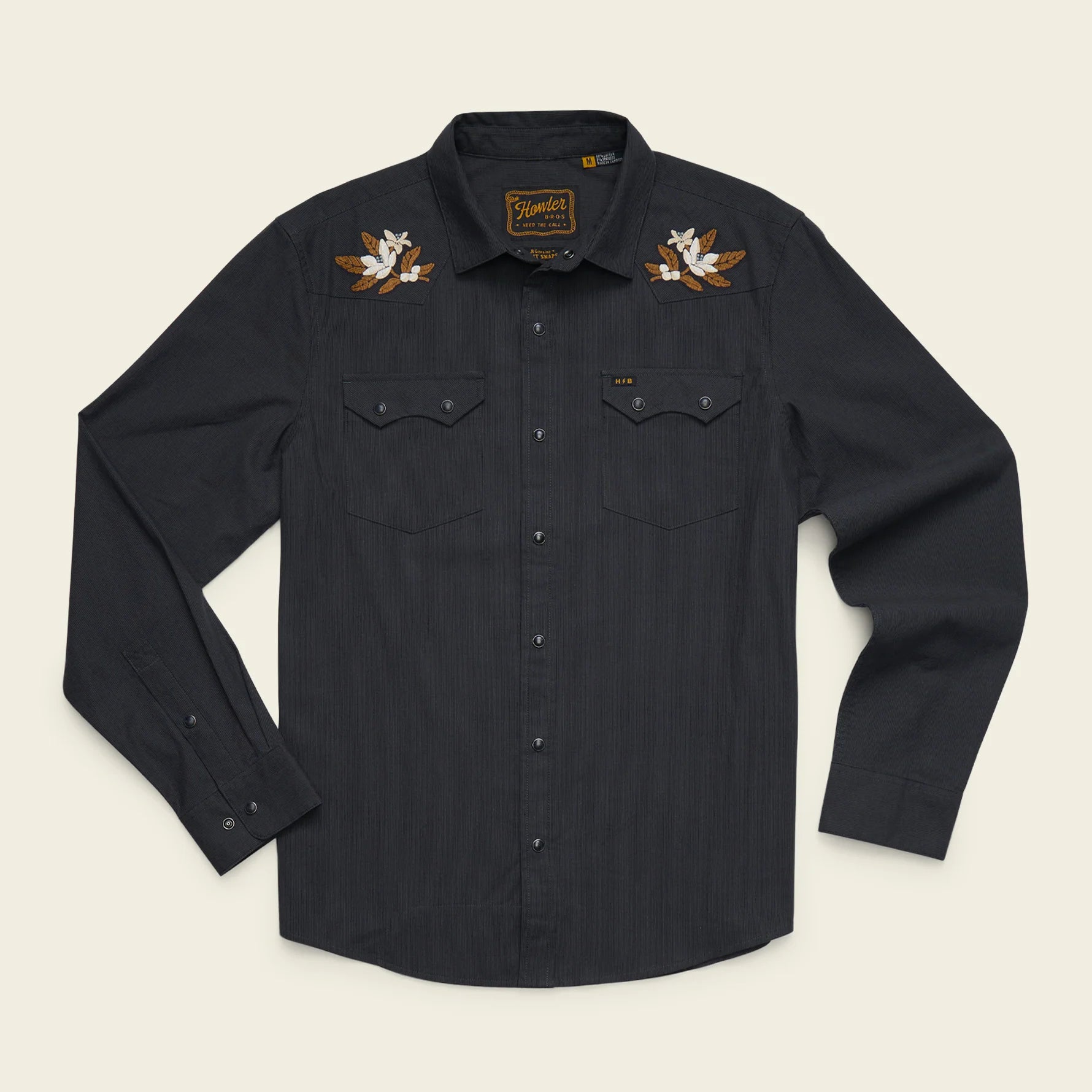 A dark charcoal gray long-sleeve button-up shirt with embroidered western-style bird motifs on the shoulders, displayed flat against a light cream background.