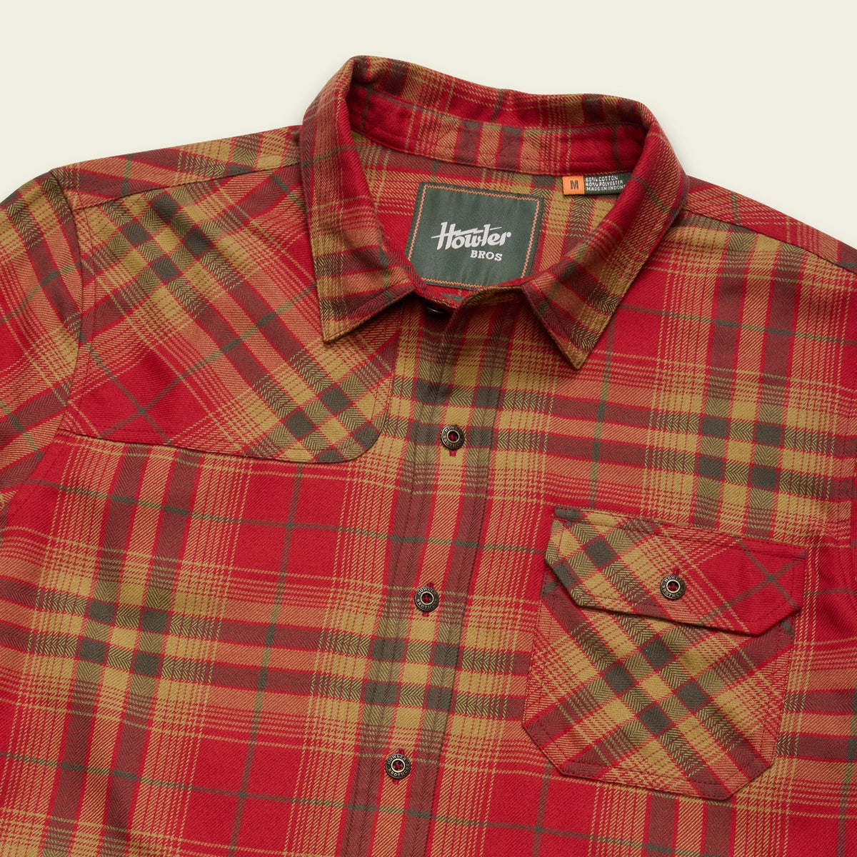 A close-up of a plaid button-up shirt by Hunter, featuring a red, tan, and dark green tartan pattern. The collar label clearly displays the 'Hunter 8012' branding.
