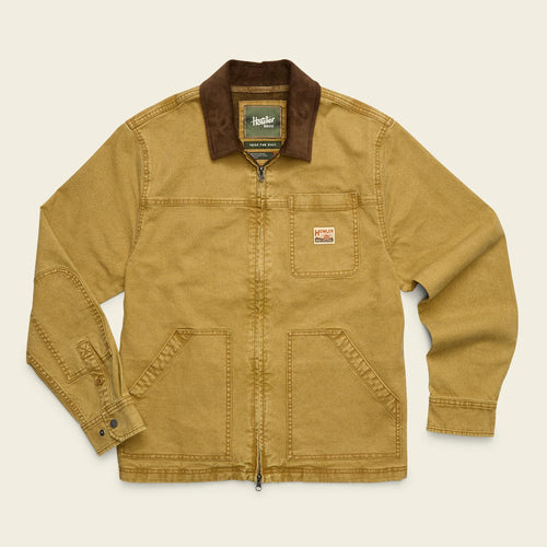 A tan canvas utility jacket with a brown corduroy collar, featuring a front zipper, chest pocket, and lower patch pockets, laid flat against a light cream background.
