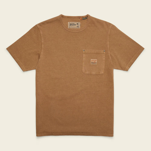A brown short-sleeve crewneck t-shirt with a chest pocket, laid flat against a light cream background. The pocket features a small brown leather brand patch, and the inner neck label reads 'Fossil'.