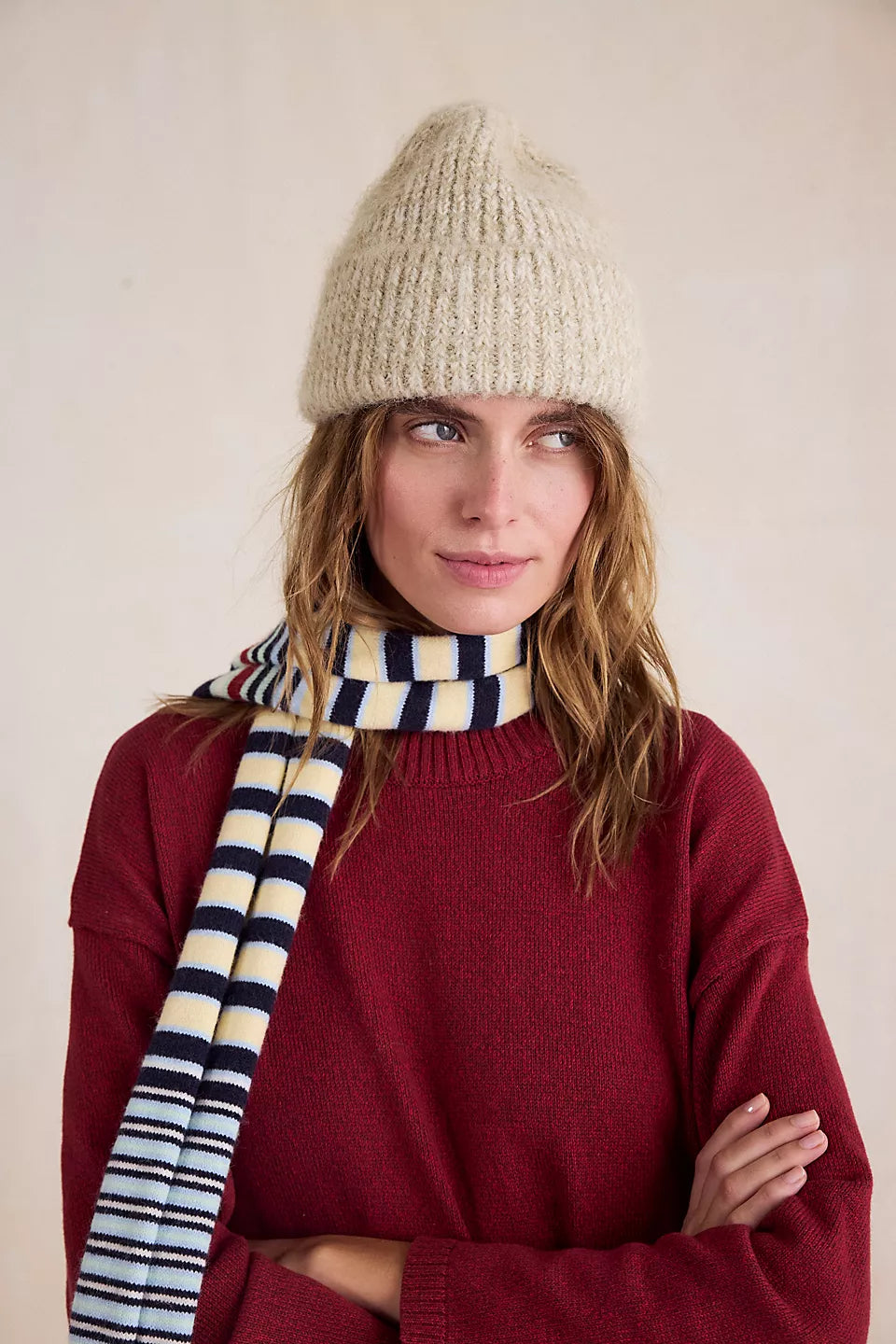 Free People Frostline Beanie in Ivory on model wearing a striped scarf and red sweater