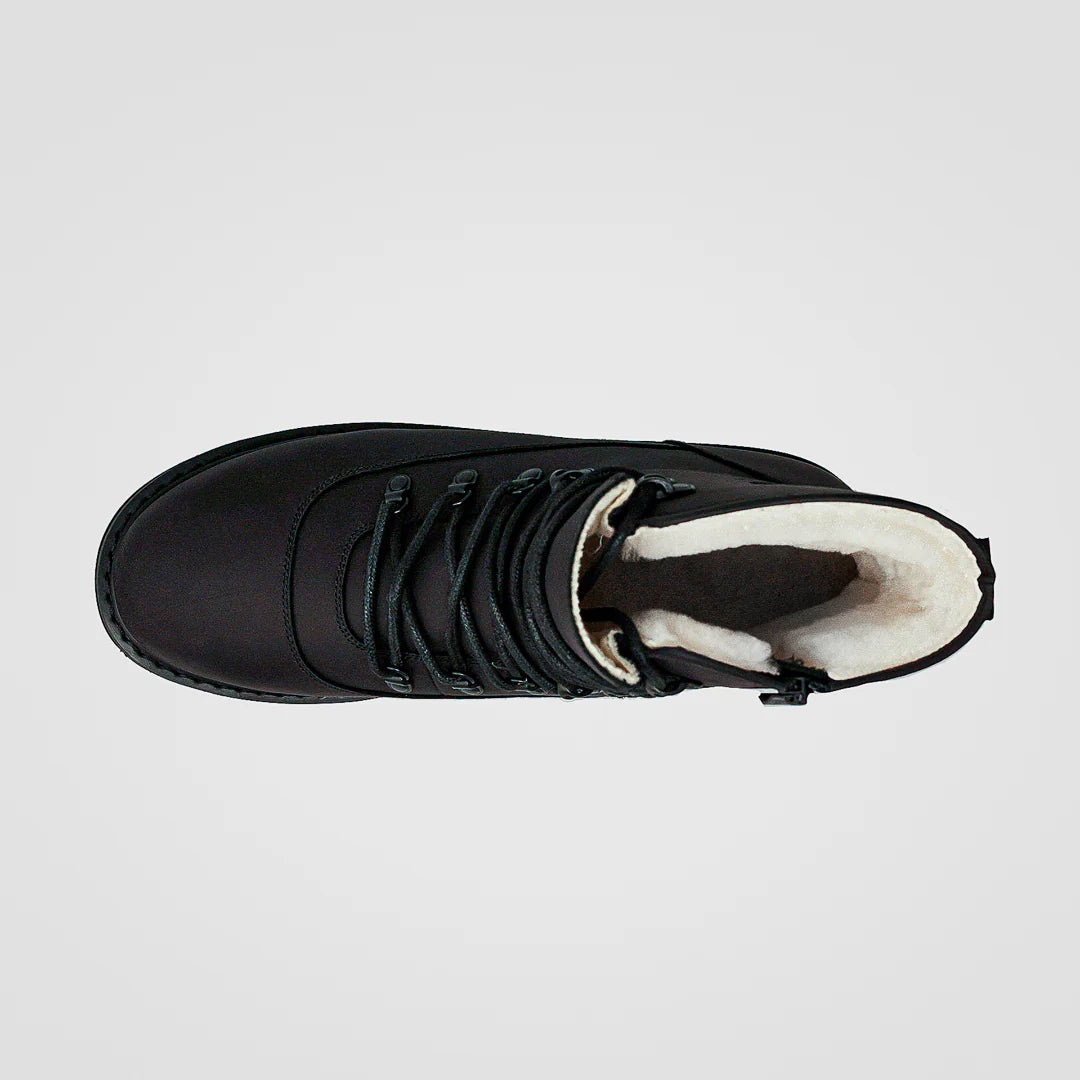 Black winter boot with white lining on a light gray background