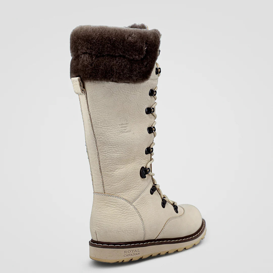 Beige winter boot with brown fur lining on a light gray background