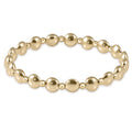 Gold beaded bracelet on a white background