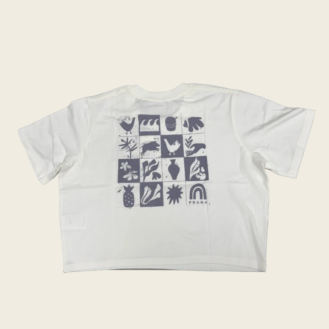 White crop top with black geometric pattern on a gray surface