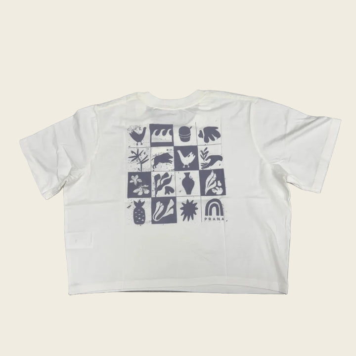 White crop top with black geometric pattern on a gray surface