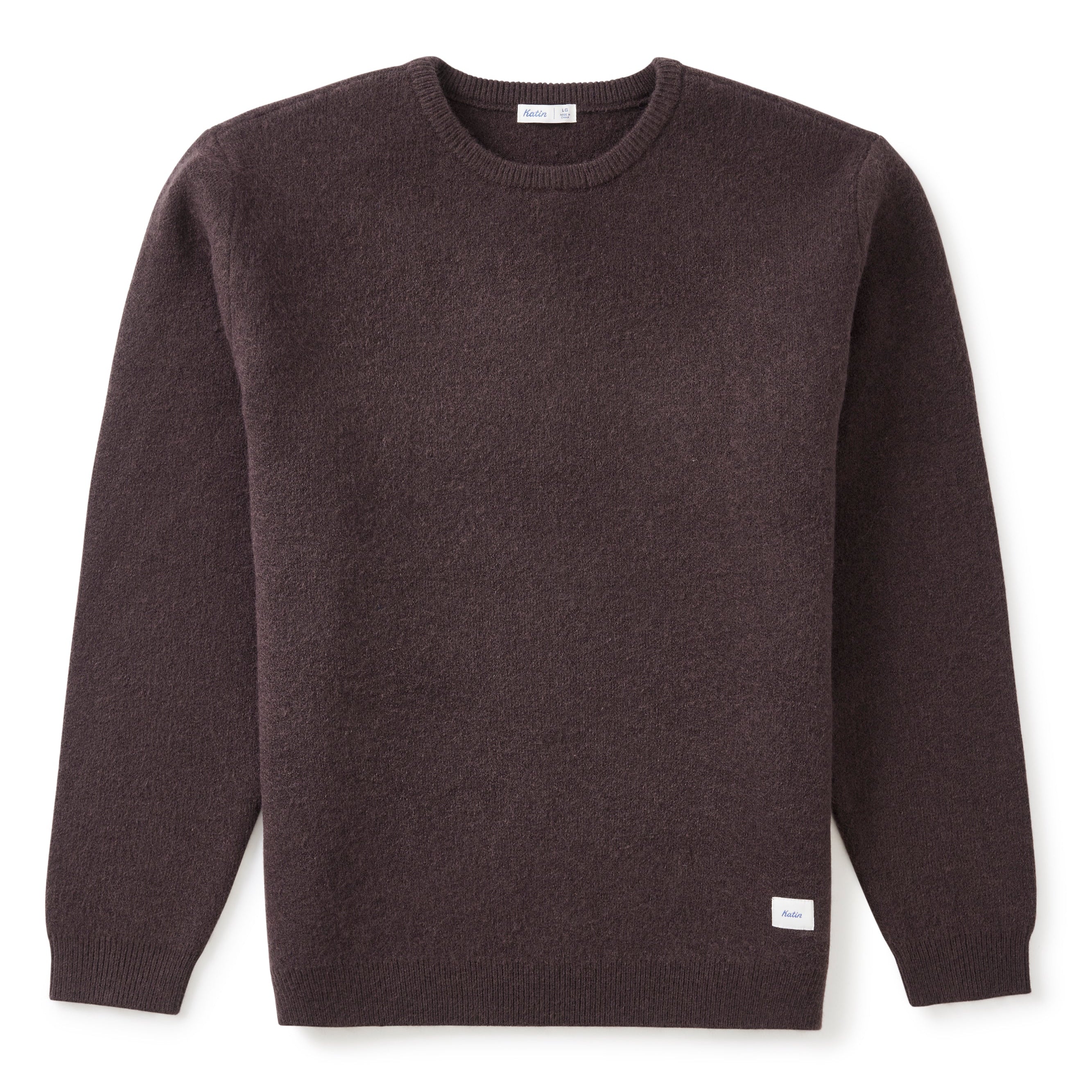 A dark brown crewneck sweater with long sleeves, laid flat against a white background.