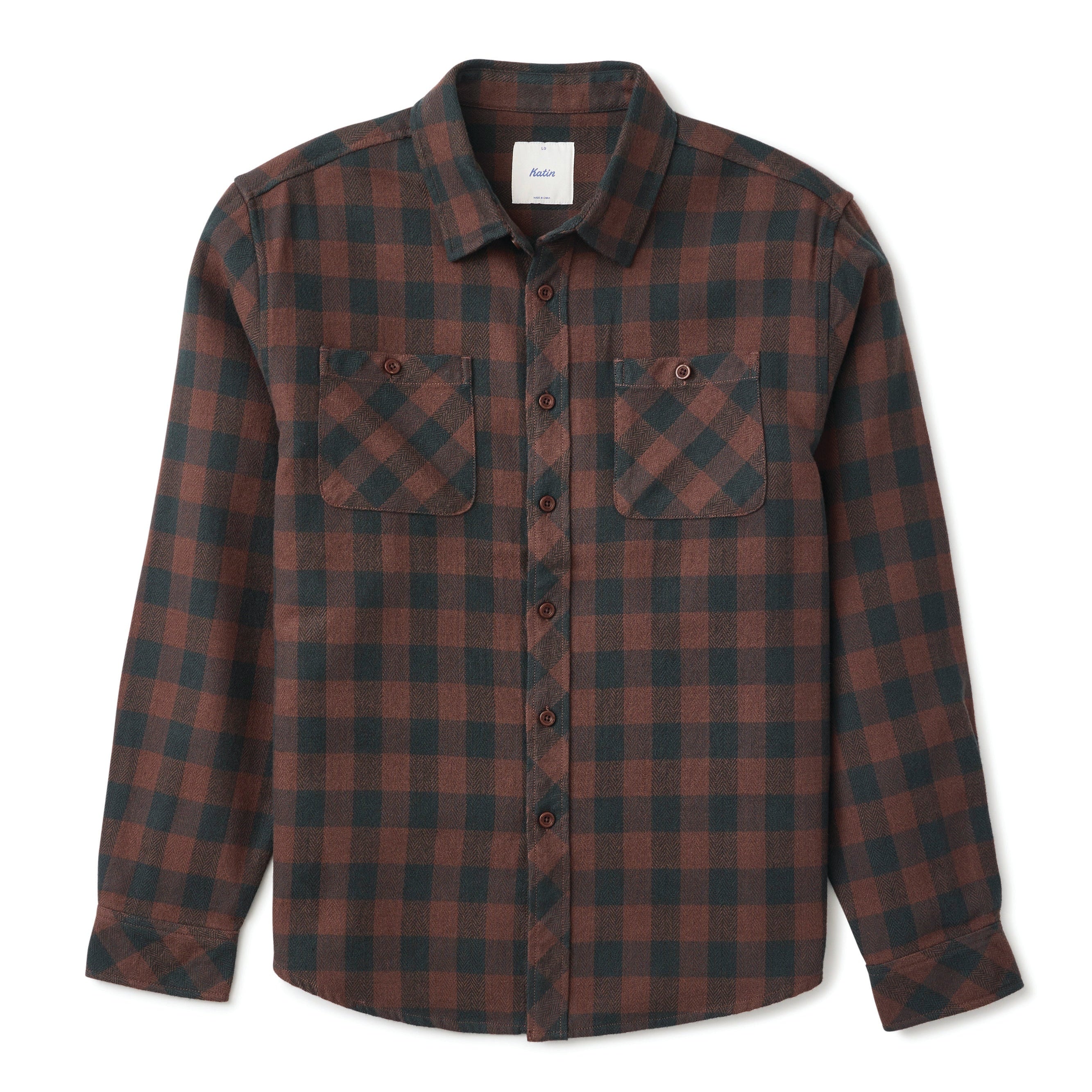 A long-sleeve button-up flannel shirt with a dark brown and black plaid pattern, featuring two chest pockets, shown on a light gray background.