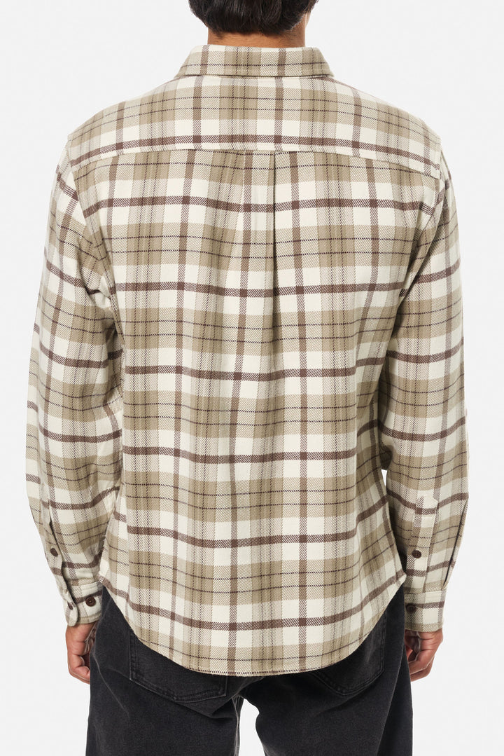Plaid shirt worn by a person on a white background