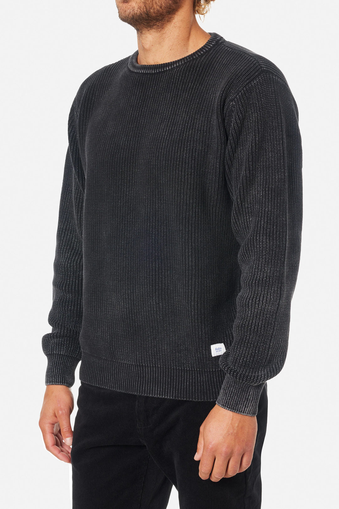 Man wearing a dark gray textured sweater on a white background