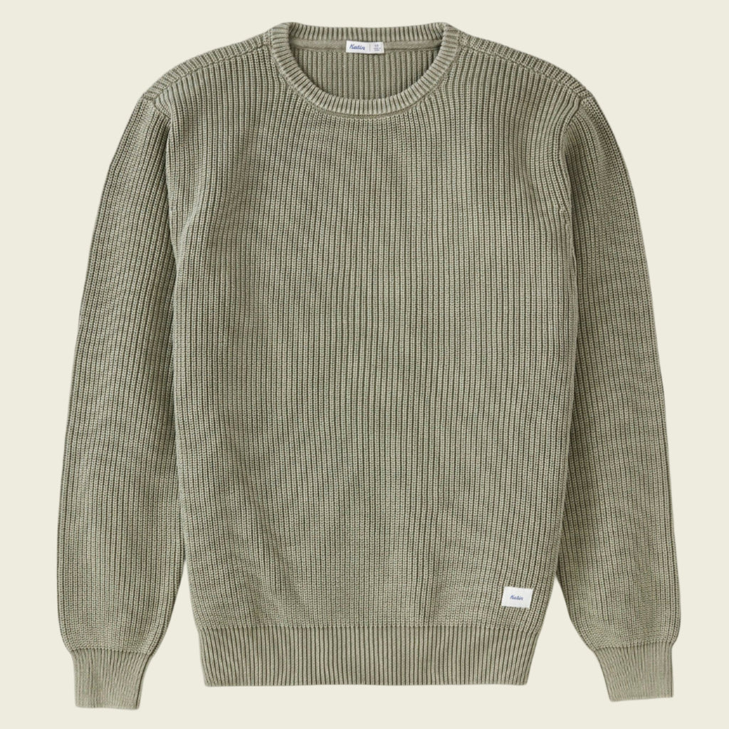 Green ribbed sweater on a white background