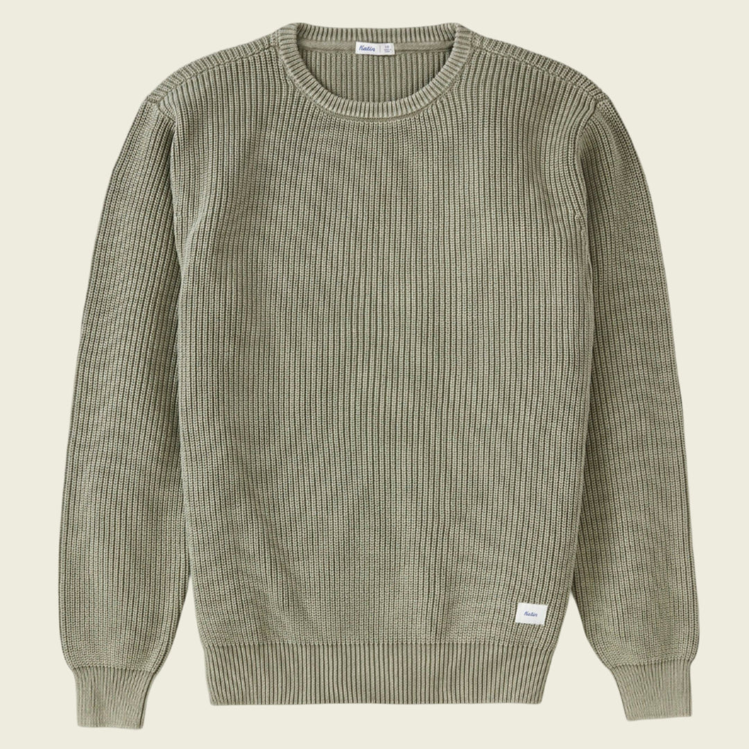 Green ribbed sweater on a white background