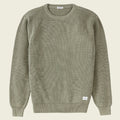 Green ribbed sweater on a white background