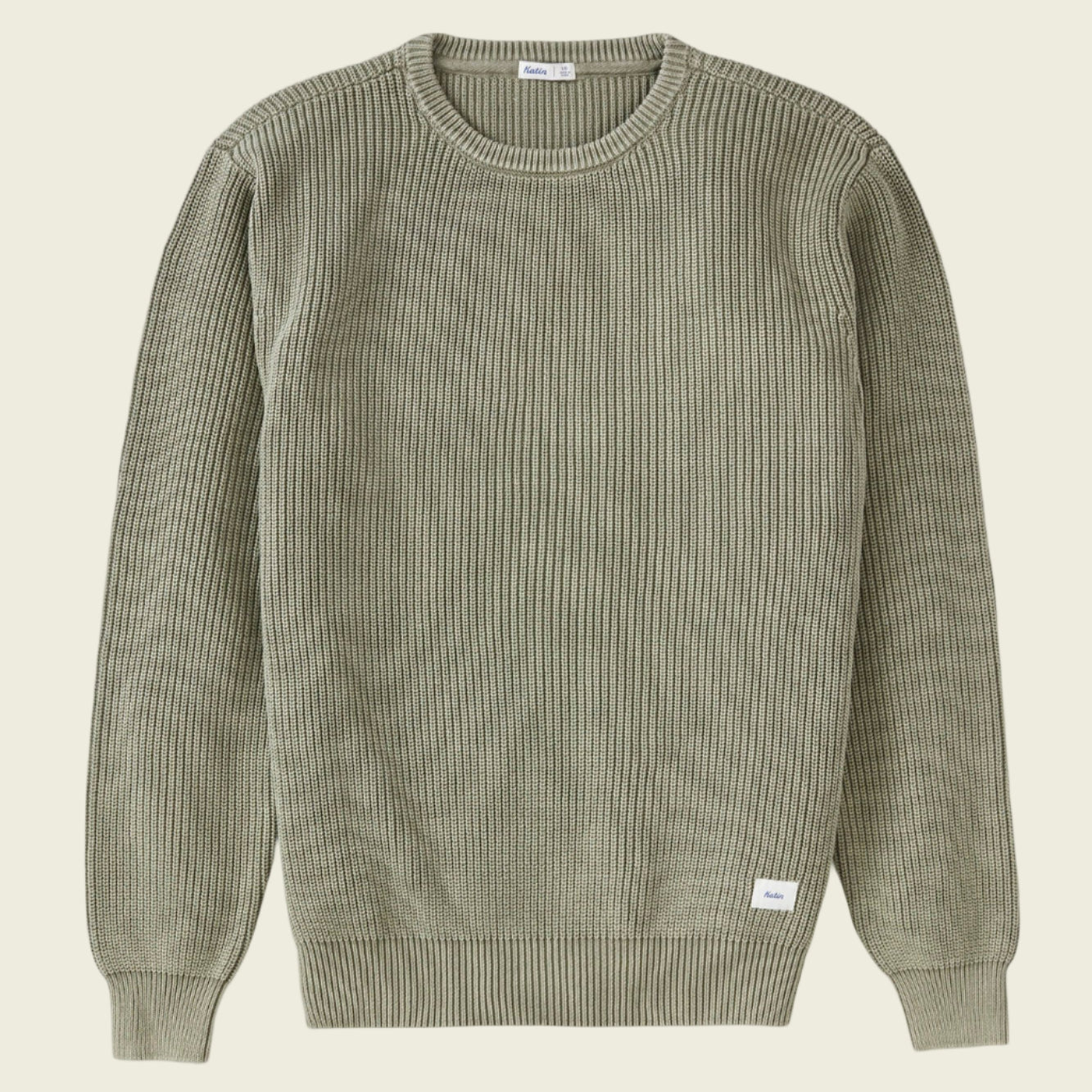 Green ribbed sweater on a white background