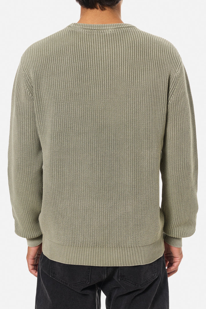 Person wearing a green sweater on a white background