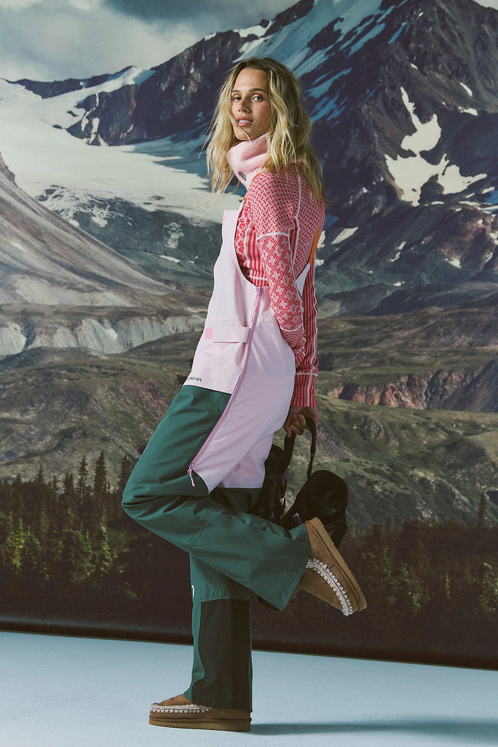 Person in ski attire with a mountainous landscape in the background
