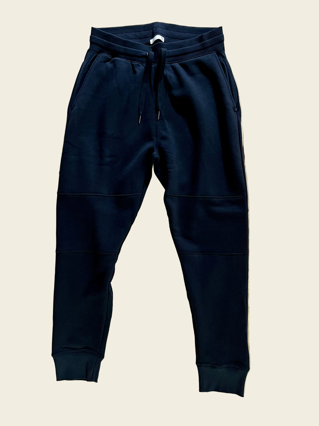 A pair of black Tasc Men's Legendary Fleece Joggers laid flat on a surface