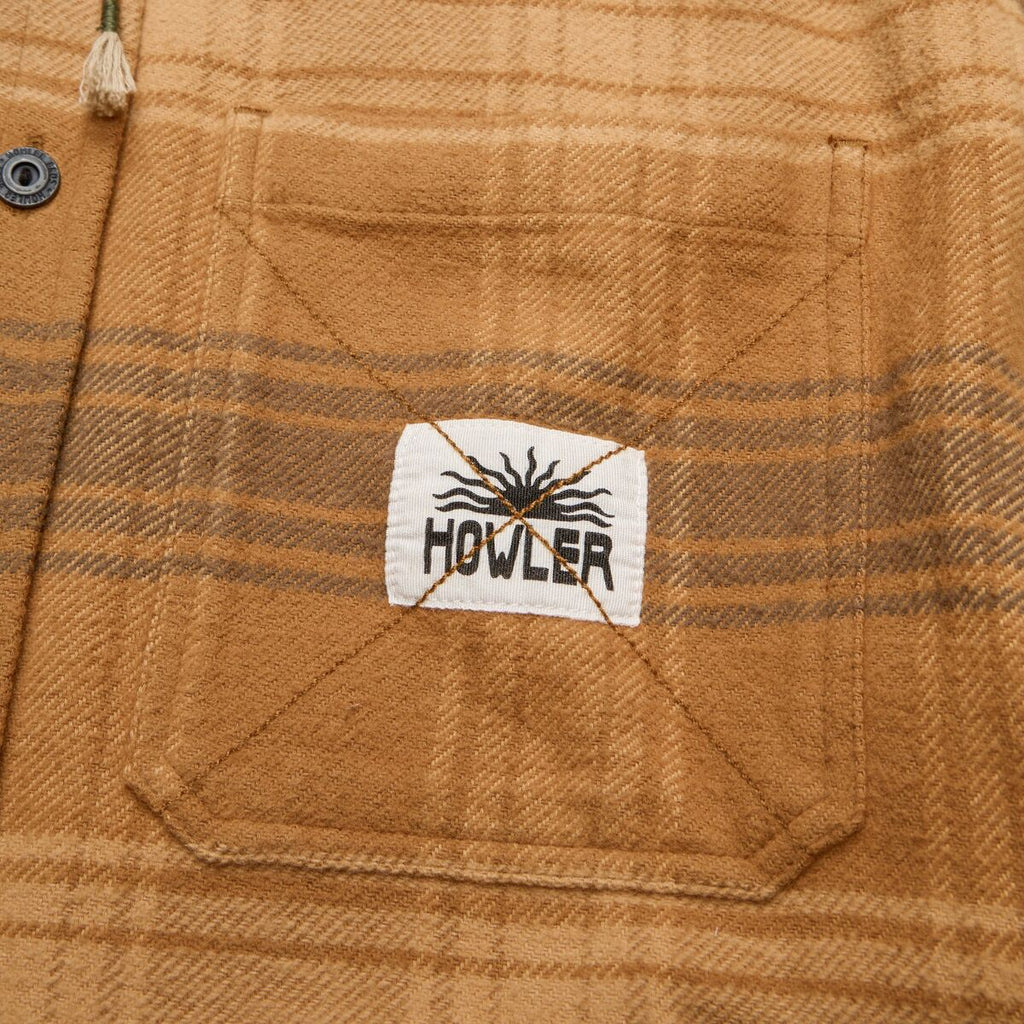 Close-up of a plaid fabric with a Howler brand label.