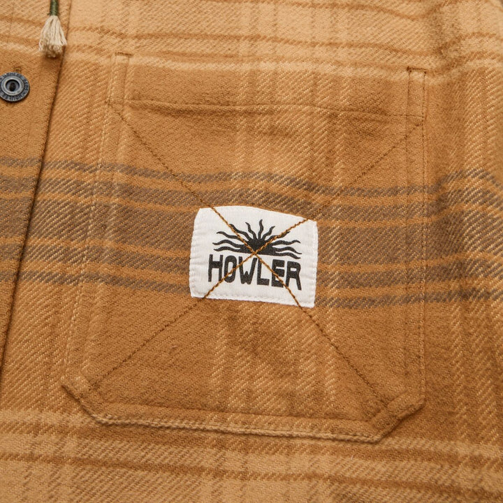 Close-up of a plaid fabric with a Howler brand label.