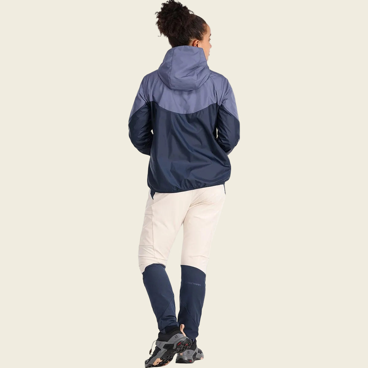 Person wearing a two-tone jacket with a white background