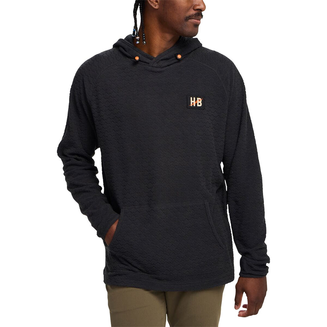 Person wearing a dark gray hoodie with a logo on a white background