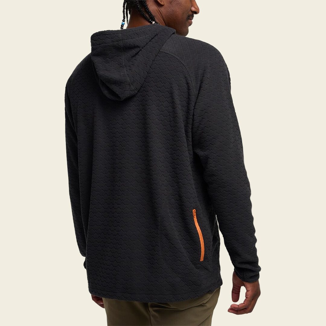 Person wearing a black hoodie with an orange zipper on a white background