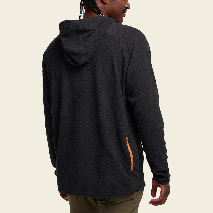 Person wearing a black hoodie with an orange zipper on a white background