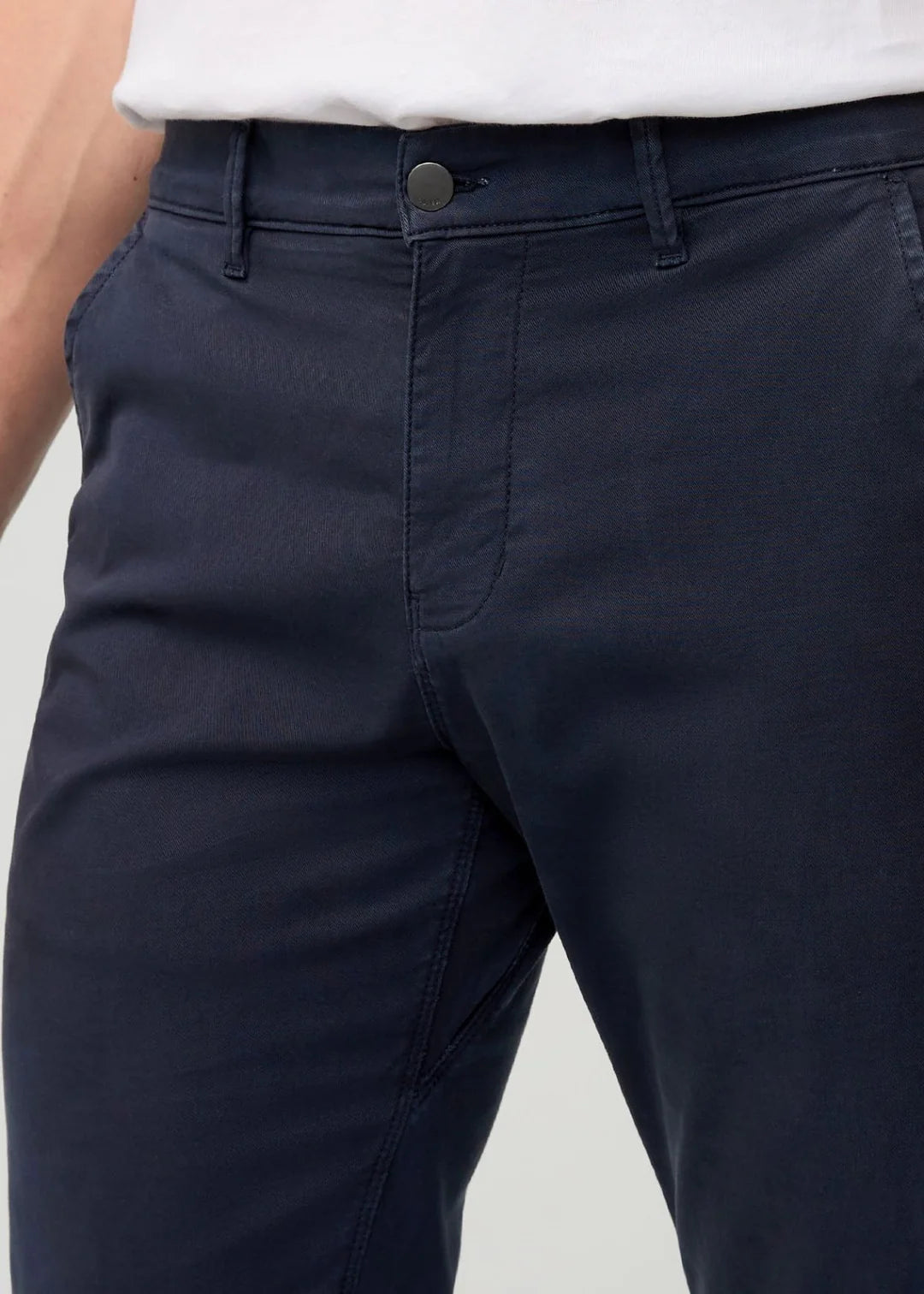 Navy pants with a white shirt on a light gray background