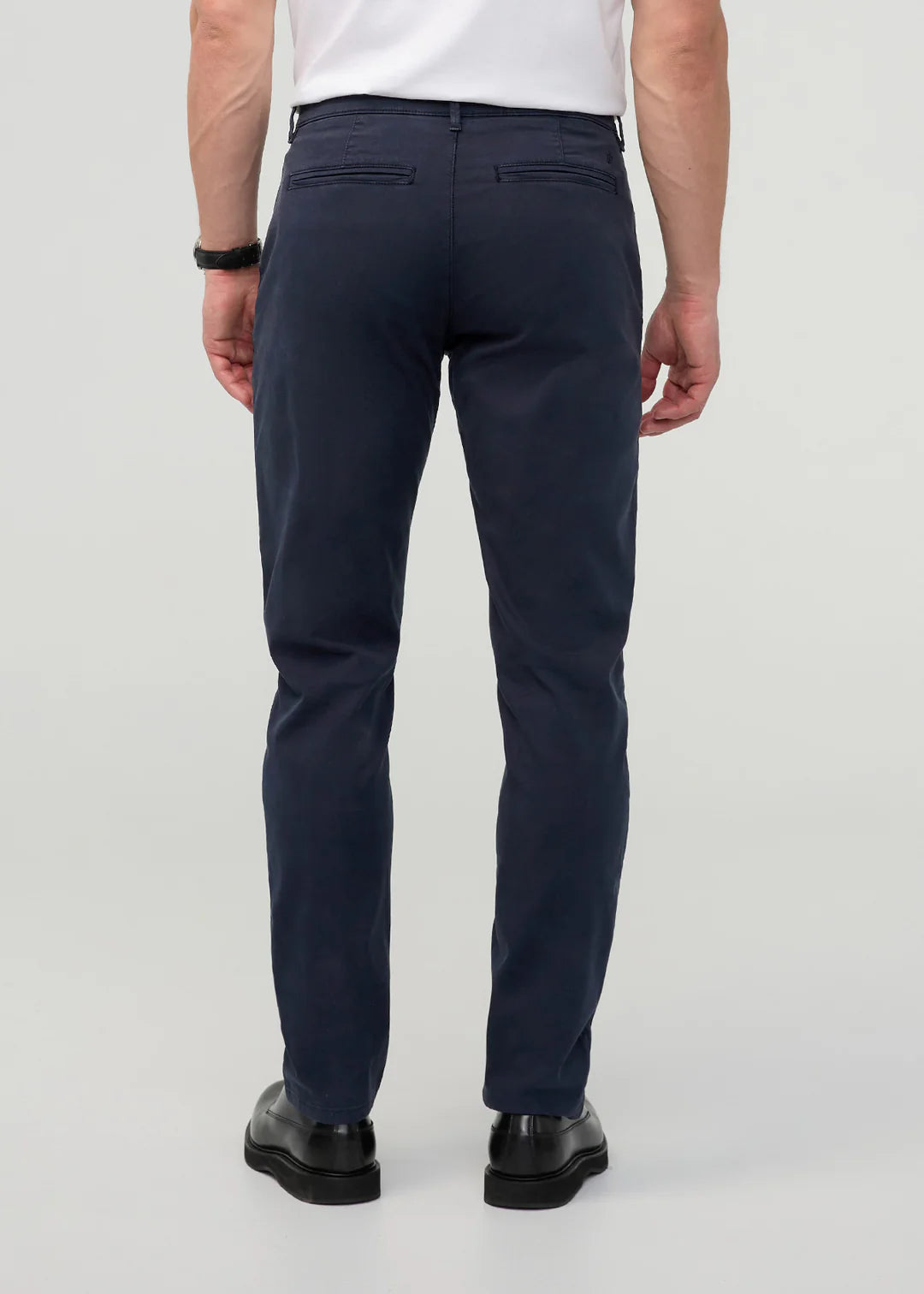 Person wearing navy pants on a white background
