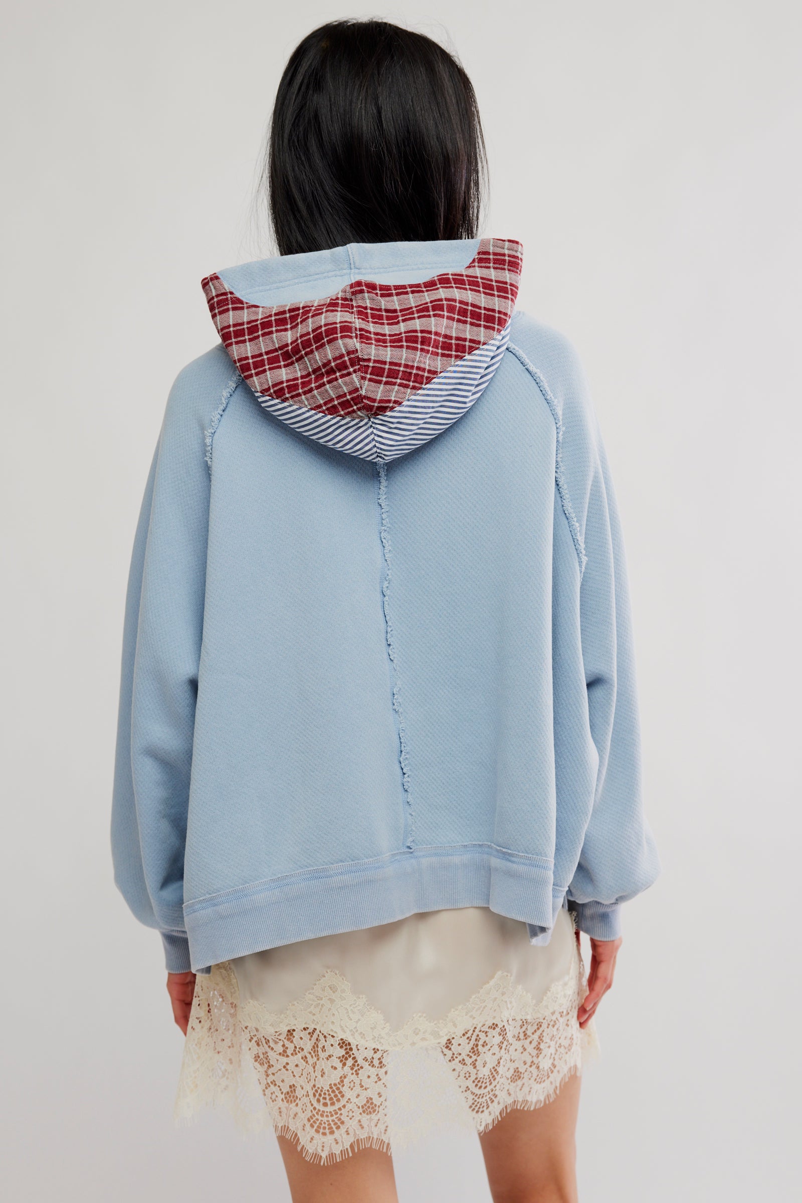 Free People Countryside Hoodie in Autumn Sky on model wearing a lace skirt with white background-back view