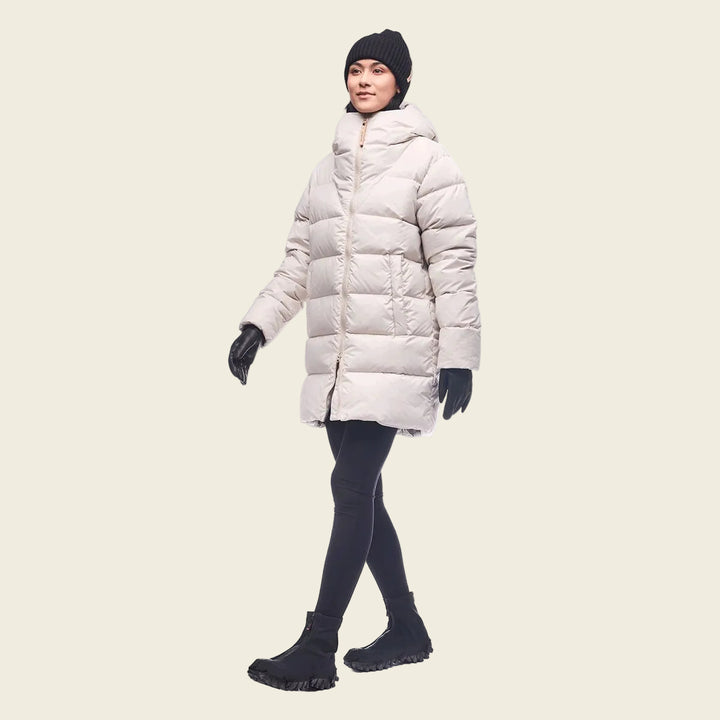 Person wearing a long white puffer coat on a white background