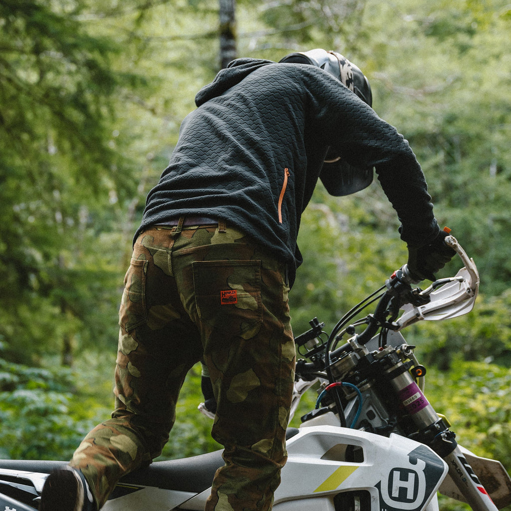 Person on a motorcycle in a forest setting