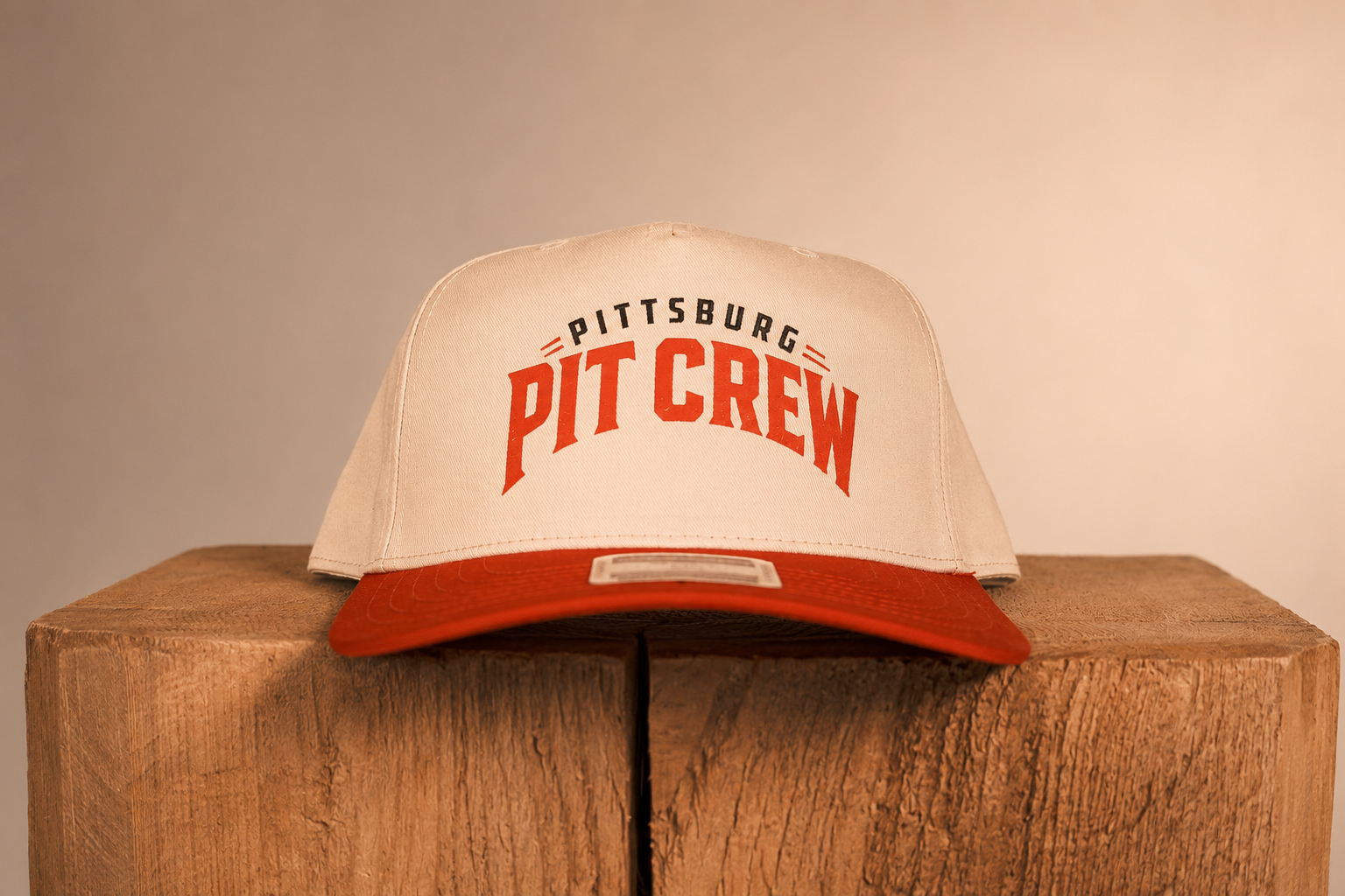 Red brim hat with Pittsburg Pit Crew on it