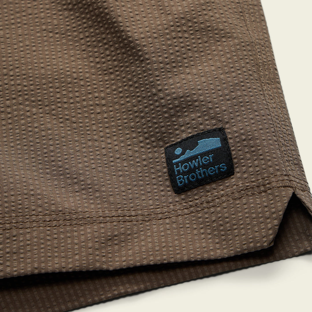 Brown fabric with a Howler Brothers logo patch on a beige background