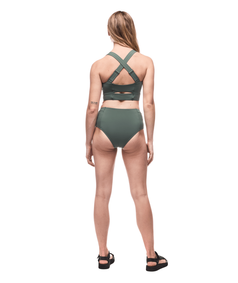 Woman wearing a green bikini set on a white background