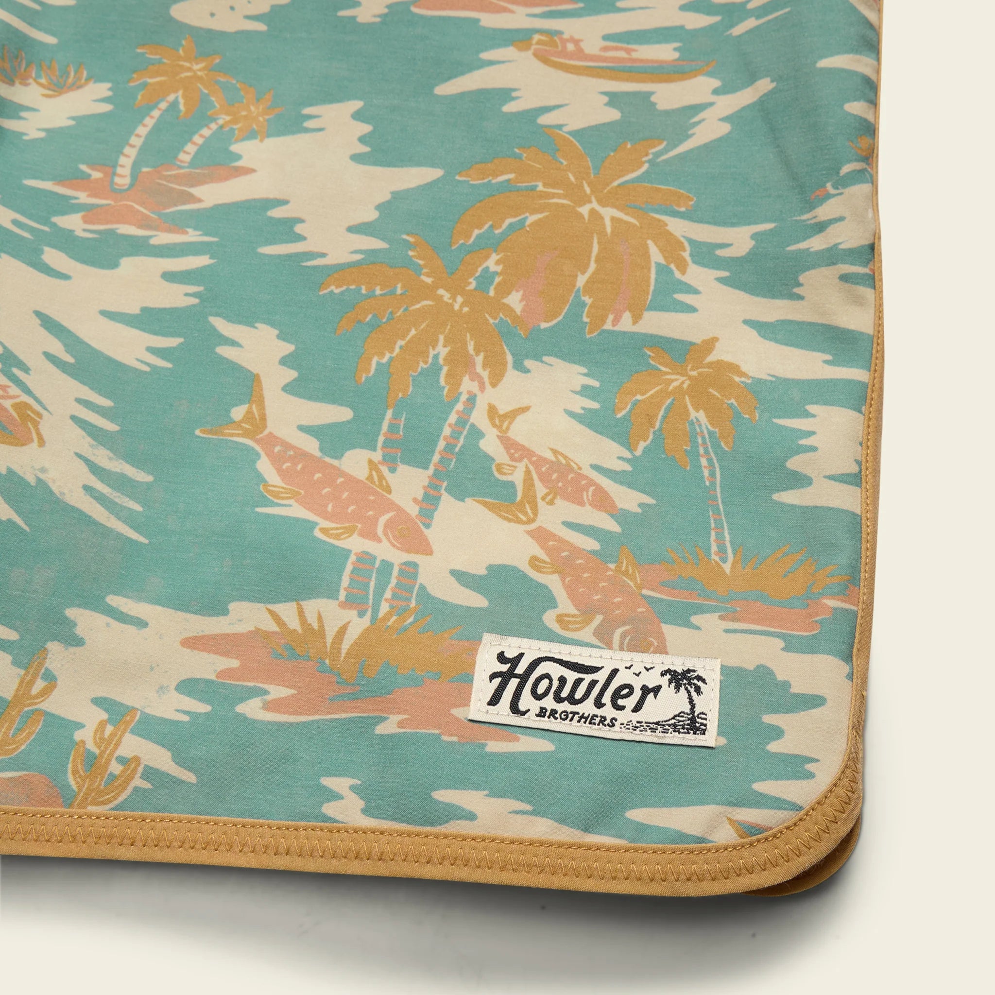 Palm tree patterned fabric with Howler Brothers label on a white background