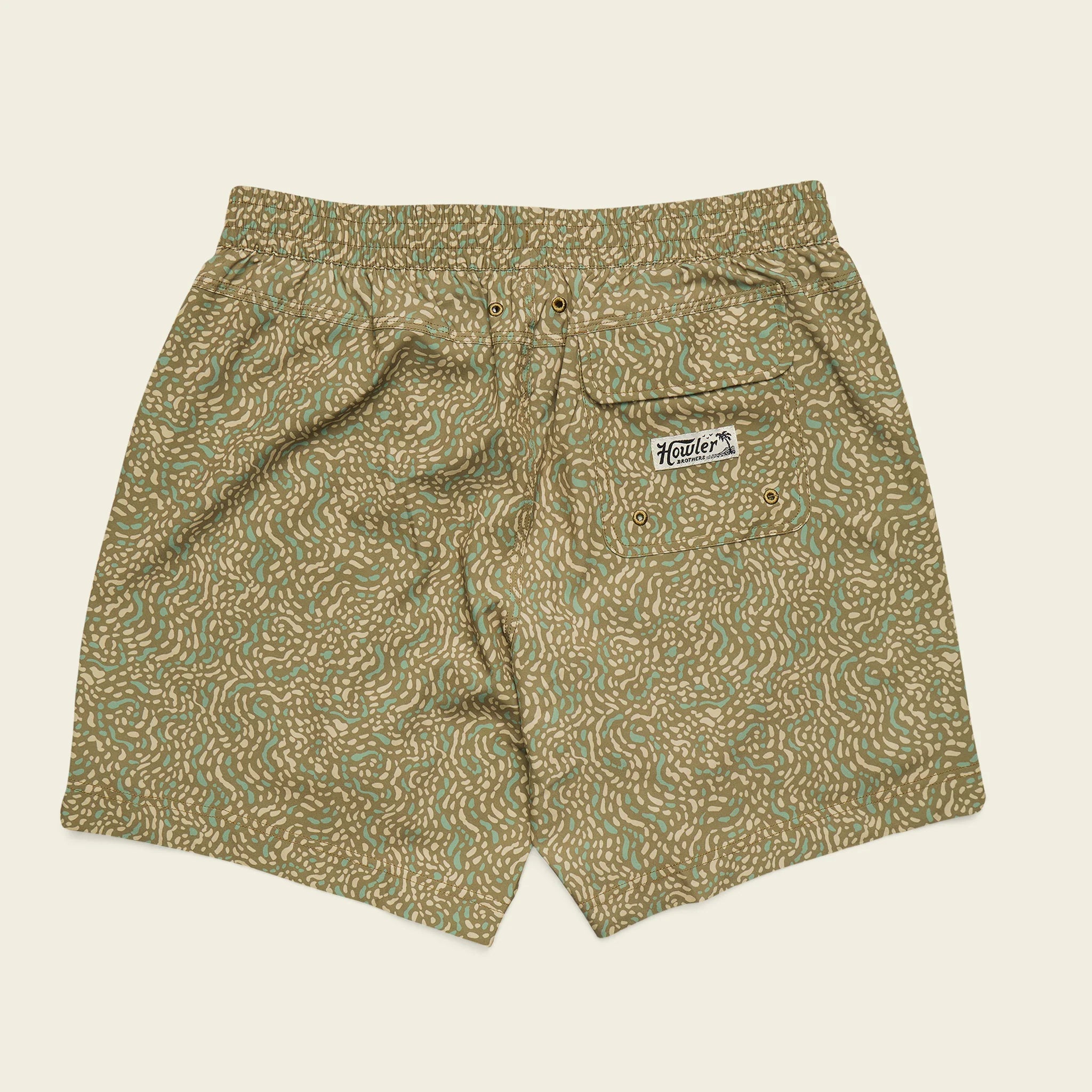 Patterned shorts with a brand logo on a beige background