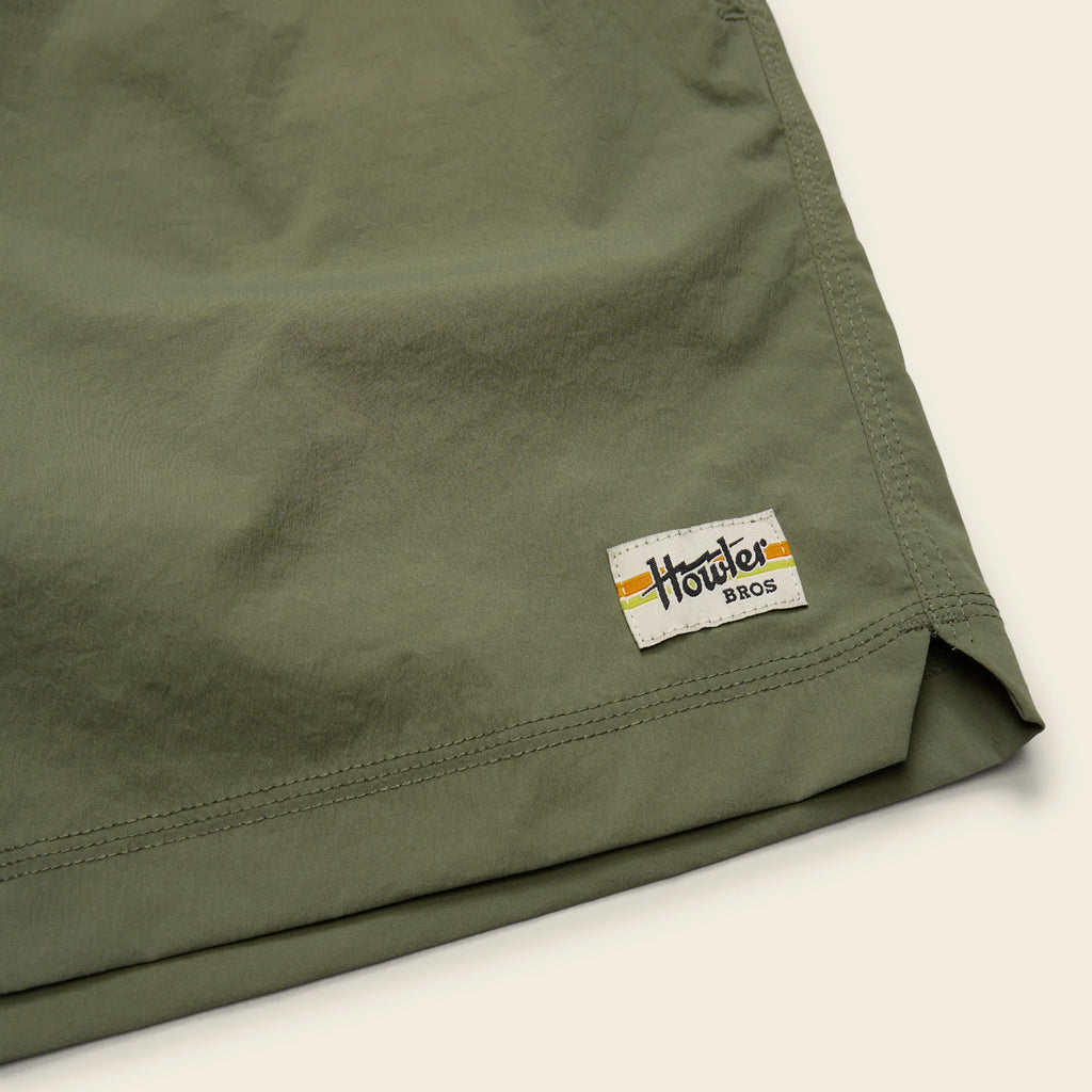 Green shorts with a visible brand logo on a light background