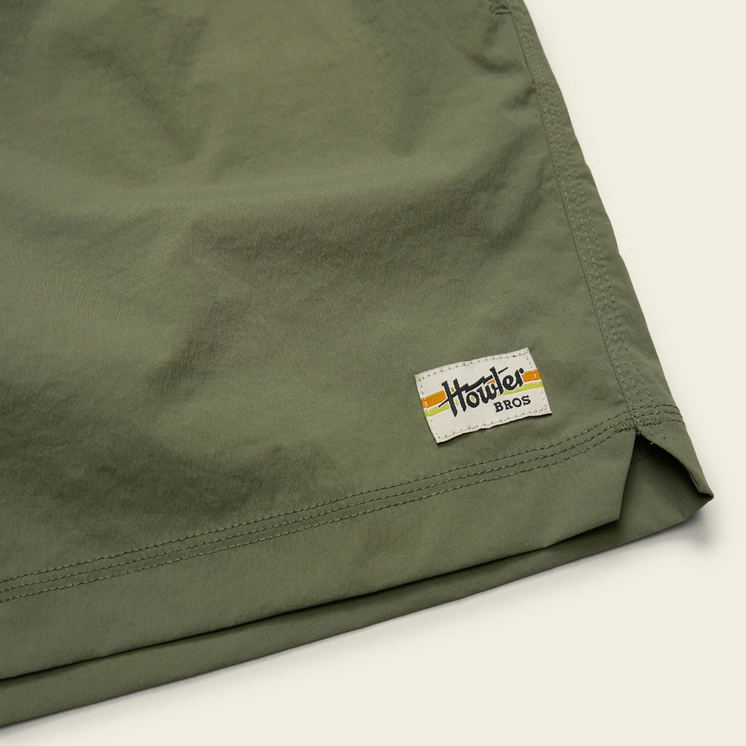 Green shorts with a visible brand logo on a light background