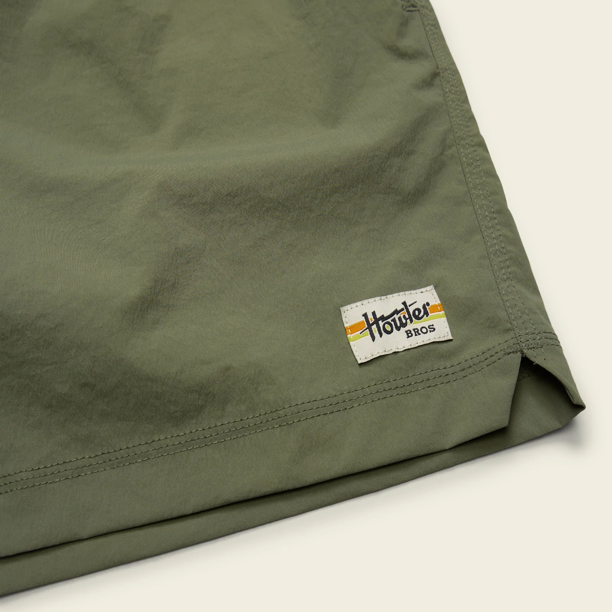 Green shorts with a visible brand logo on a light background