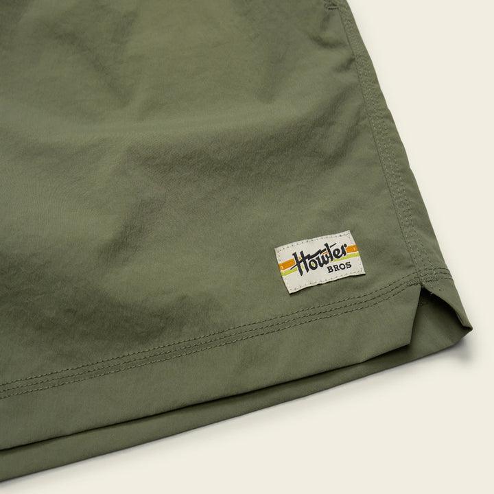 Green shorts with a visible brand logo on a light background