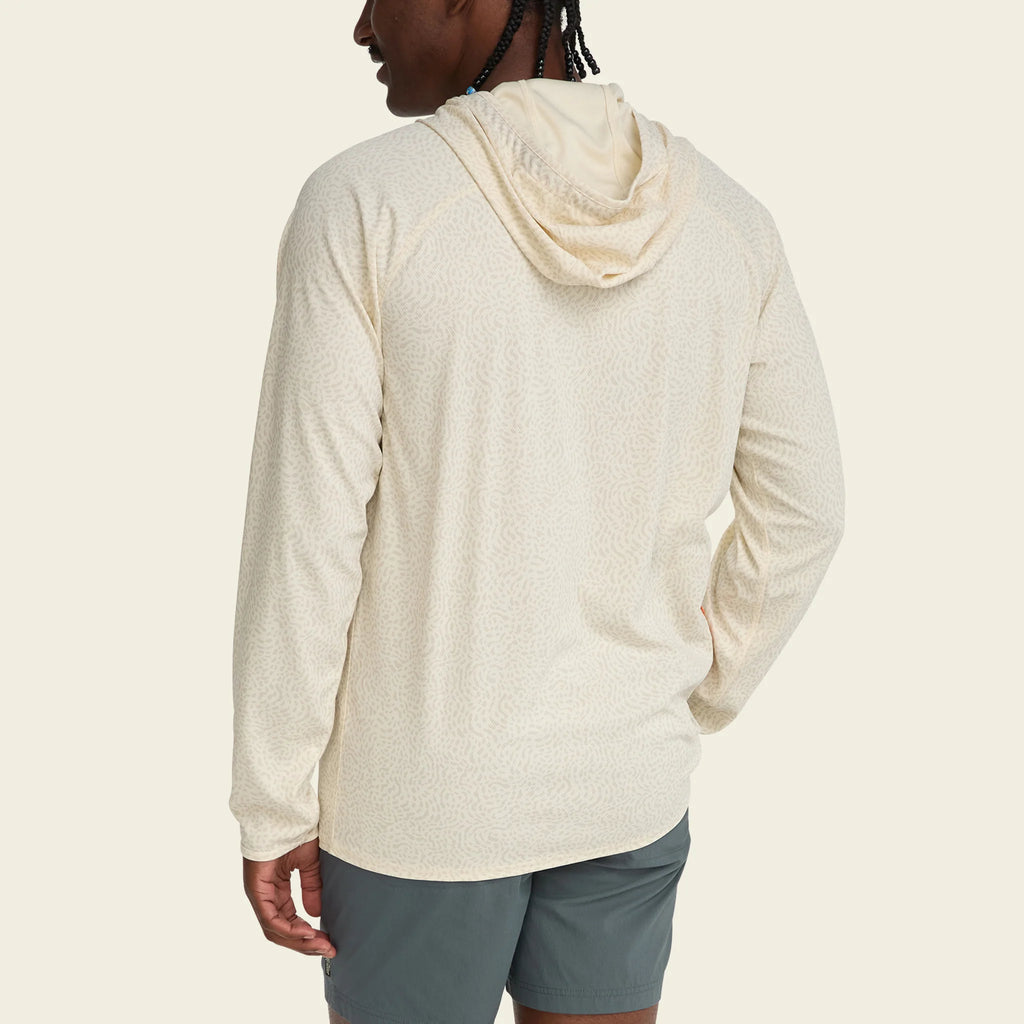 Person wearing a beige hoodie and gray shorts on a plain background