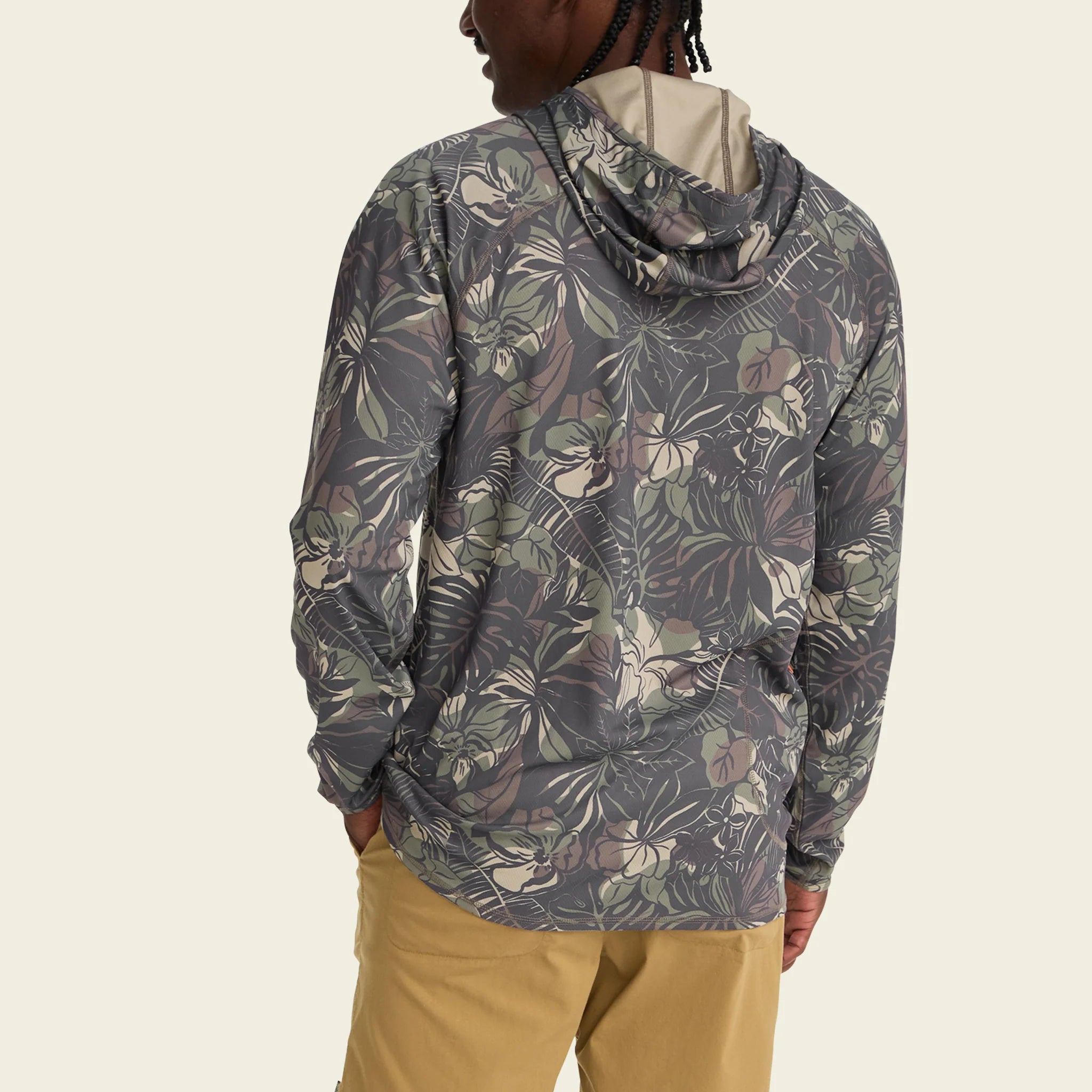 Person wearing a patterned jacket on a beige background